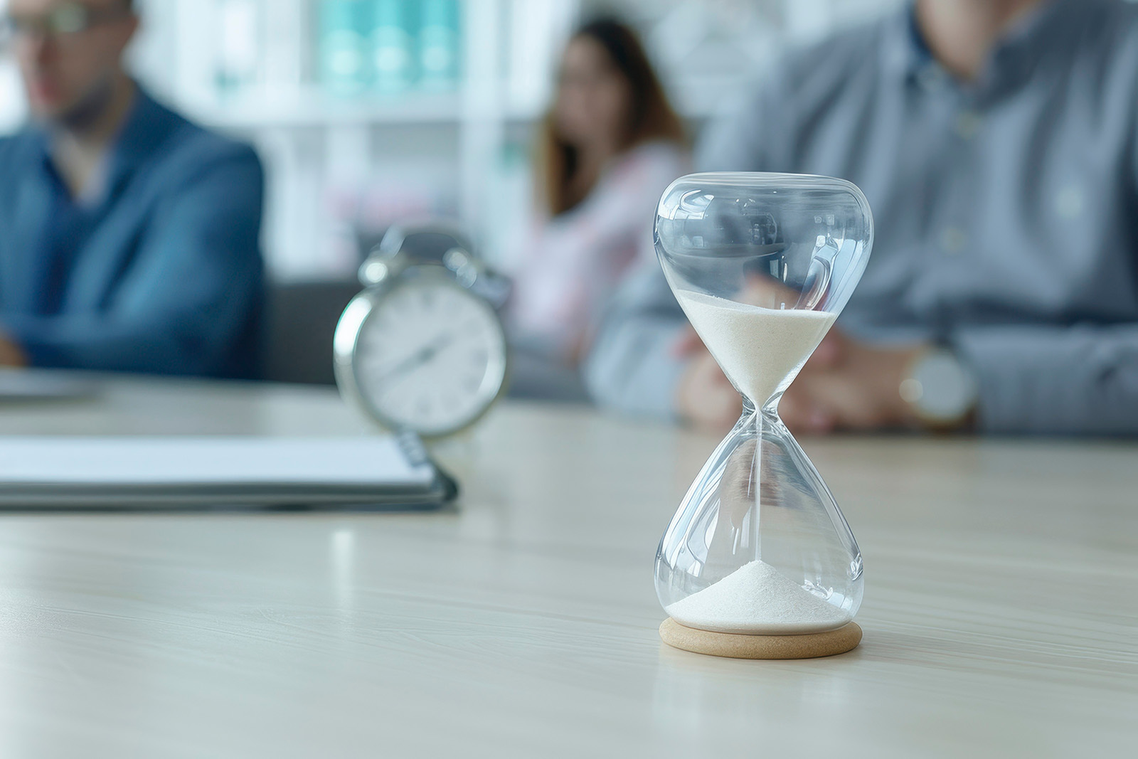 Time to Hire - Hour glass on office desk